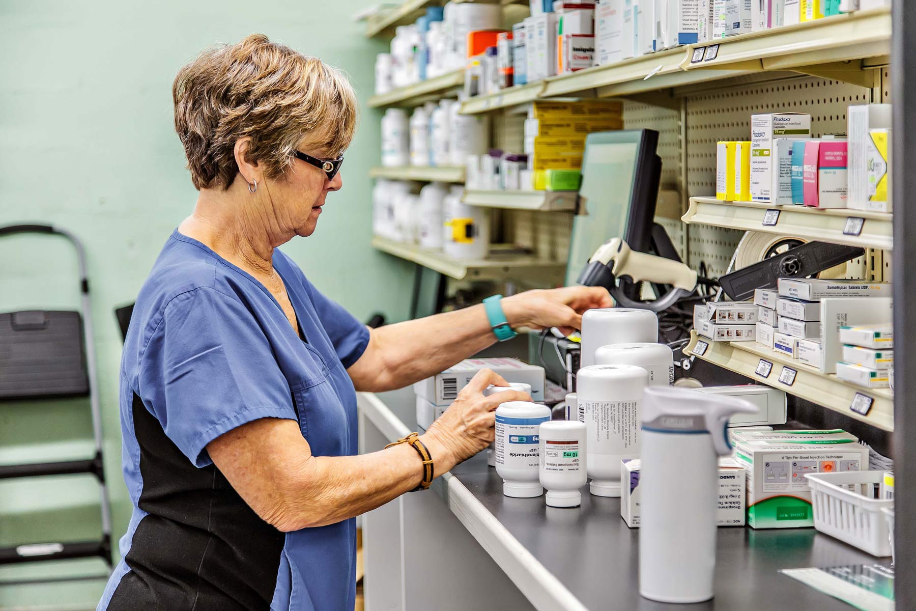 wolfe's pharmacy Technician gathers stock bottles