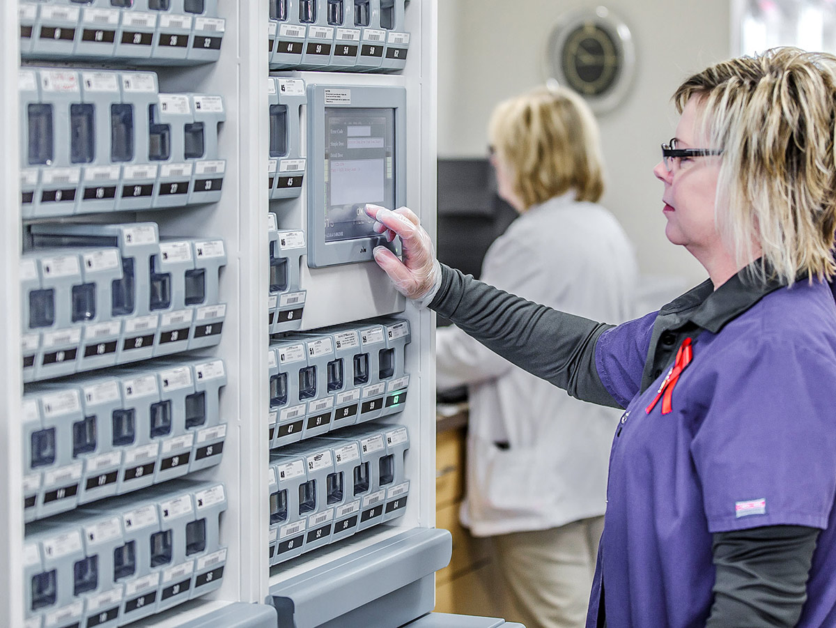 Medicatp technician starts a batch of strip packaging for a patient on multiple medications