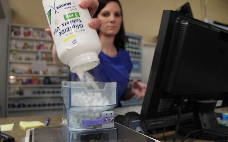 walberg family pharmacy technician replenishes a PASS canister