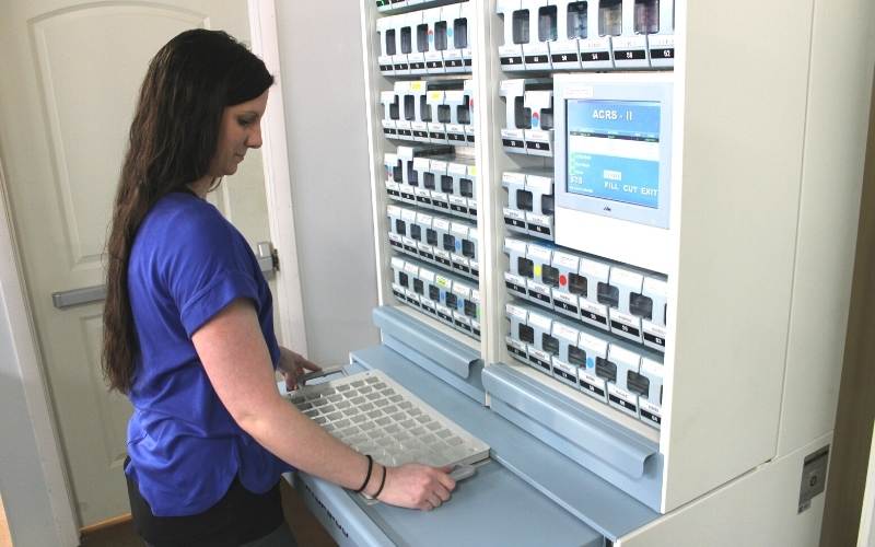 Walberg technician adds tablets to the batch with the STS tray